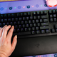 A photo of a hand resting on the Razer huntsman v2 keyboard